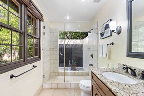 A bathroom with a large window, a shower, a toilet, and a sink. - Langosta Beach Club - Casa Pariso by Jet Luxury (Tamarindo)