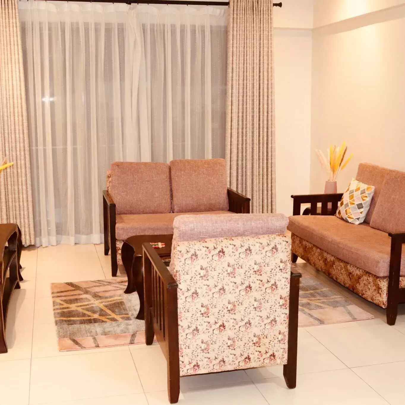 A living room with a sofa set, a coffee table, and a rug.
