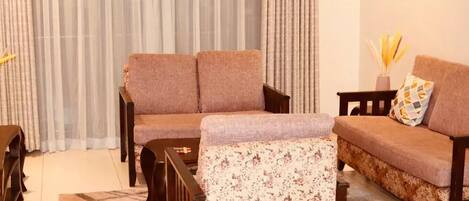 A living room with a sofa set, a coffee table, and a rug.