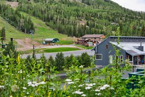A lodge with a ski lift, surrounded by forested hills. - Ski Condo in Chalet Village at Brian Head! (Brian Head)