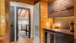 A modern kitchen with wooden cabinetry and a built-in refrigerator.