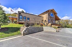 Stunning building with a covered entrance and beautifully manicured lawn.