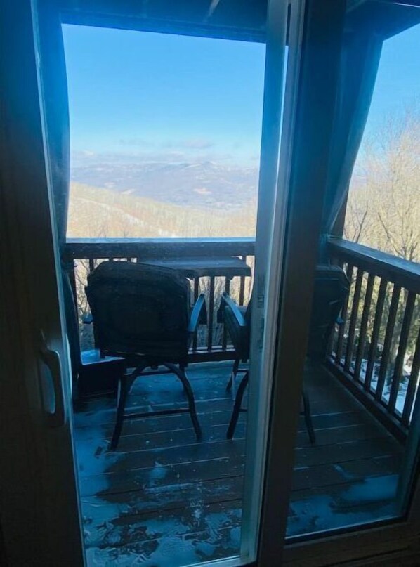 Enjoy the serene view of trees and mountains from your balcony.