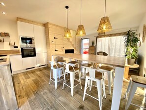Enjoy cooking in this kitchen with a central island, oven, and microwave, plus a staircase leading to a view of the city.
