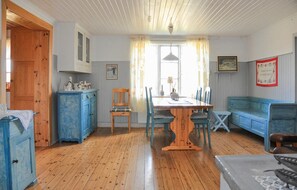 Traditional room with a dining table and chairs, a cabinet, and a bench.
