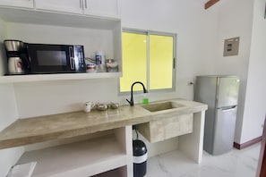 Fridge, microwave, coffee/tea maker, cookware/dishes/utensils
