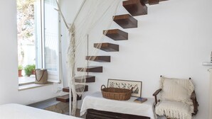 A room with a staircase, a bed, a chair, and a window with a view. - Home on the sea - Numana, prestigious sky-land with sea view (Numana)