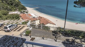 A coastal view with a beach, a parking area, and buildings with red-tiled roofs. - Home on the sea - Numana, prestigious sky-land with sea view (Numana)