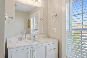 A bathroom with a white vanity, a large mirror, a faucet, and a window with blinds. - 1880's Historic Beach House... Easy Walk to the Beach, Shopping & Restaurants (Lewes)