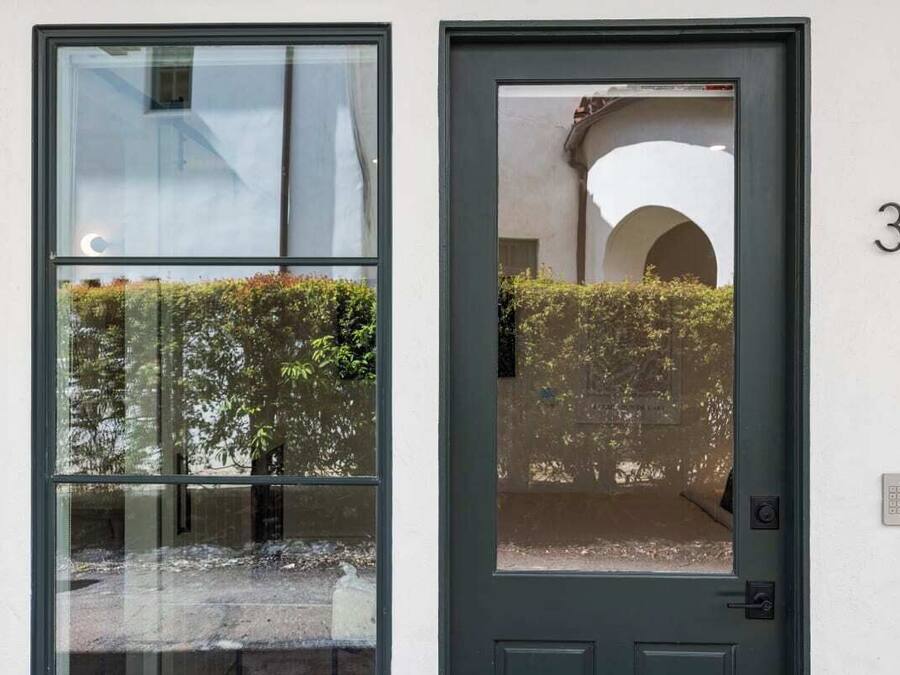 A door with a glass panel and a number '3' on the wall.