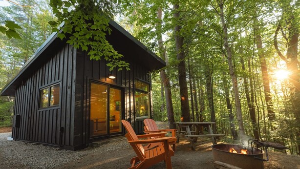 A cabin with a fire pit and outdoor seating. - Modern glamping cabin w/ full bath + kitchen - 19 (Freeport)