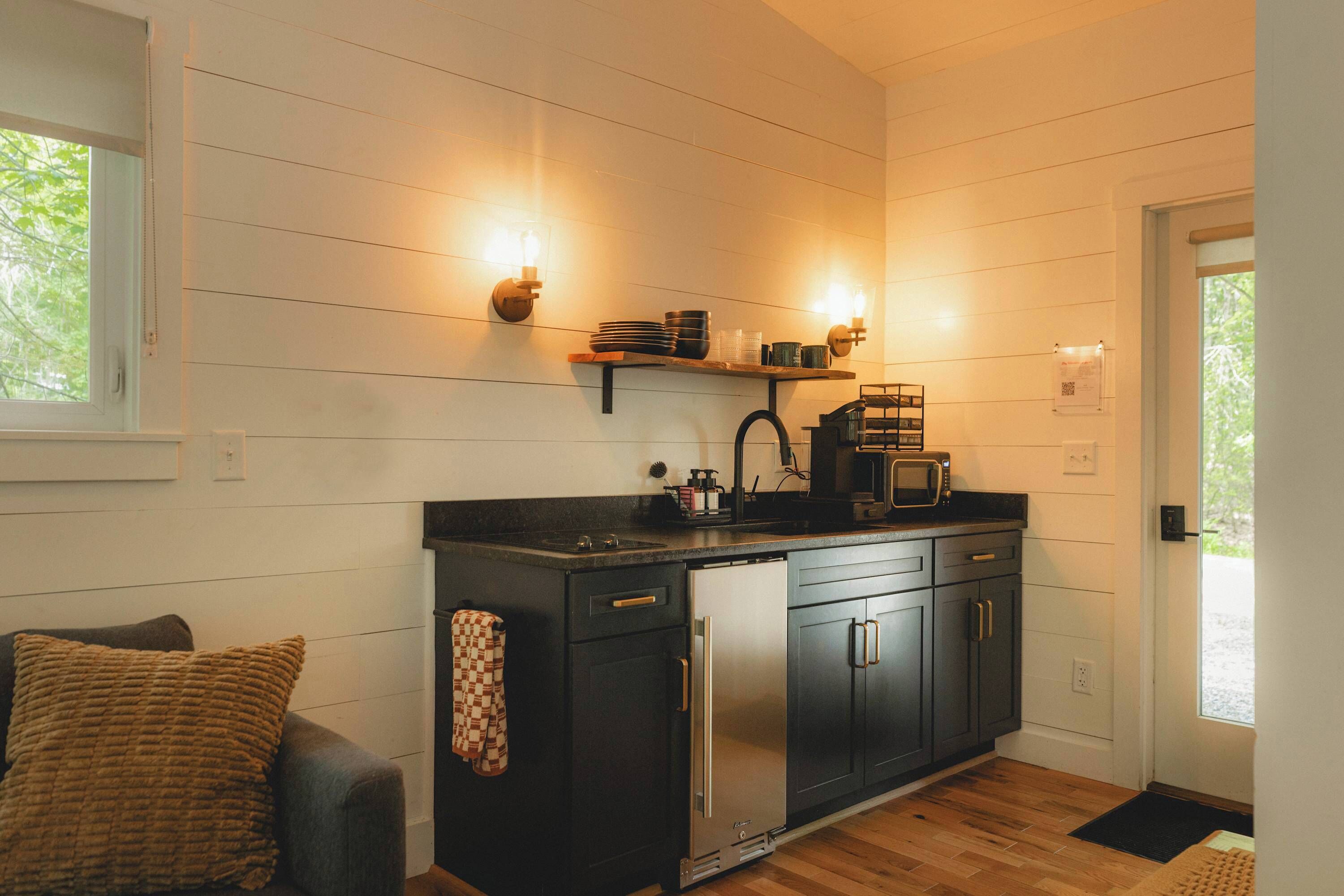 A compact kitchen with a refrigerator, microwave, and a small countertop.