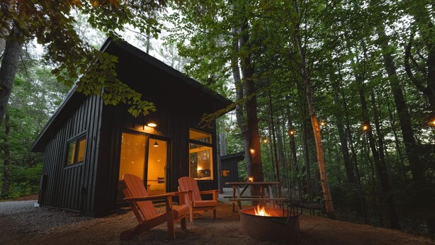 A cabin with a fire pit and outdoor seating. - Glamping cabin w/ full bath + spa access - 21 (Freeport)