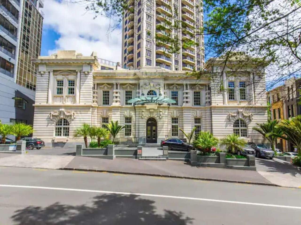 A historic building with a central entrance, large windows, and a symmetrical facade.