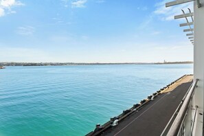 A waterfront promenade with a clear view of the water and distant cityscape. - Relaxing Sea Wharf View Apartment by Zodiak Stays (Auckland)