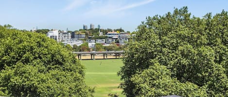 A view of a sports field with buildings in the background.