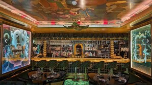 A bar area with a high ceiling, ornate ceiling artwork, and a bar counter with a variety of bottles and glasses. - A Chelsea Retreat - 2 BR with Garden and Parking (London)