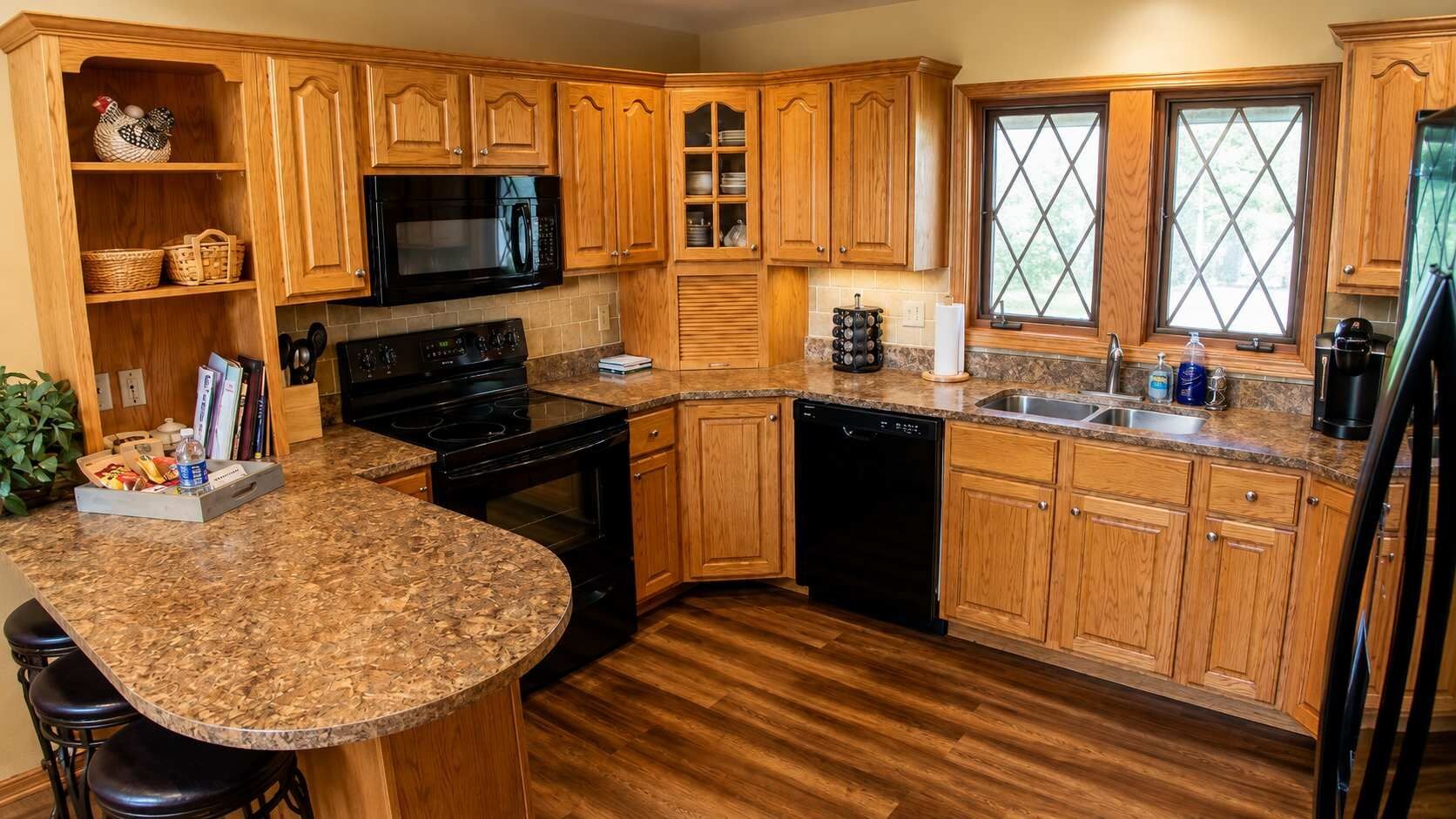 Full-size kitchen with granite countertops, a dishwasher, and plenty of cookware makes cooking for a large group easy.
