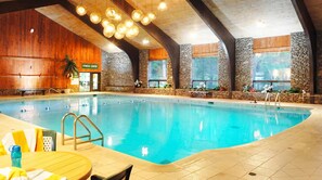 The resort's indoor whirlpool and lap pool under glass-block walls, a pay-at-the-door amenity at the Peak. The rainy-day and sore-legs answer when the lift closes.
