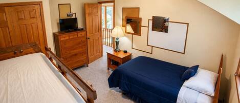 Fifth sleeper tucks into this bedroom thanks to the twin paired with a full, so the kid crew claims this room while adults take quieter beds down the hall.