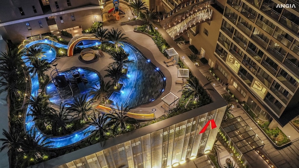 An aerial view of a hotel with a swimming pool, palm trees, and a modern architectural design. - Ocean House in The Song An Gia Vung Tau (Ho Chi Minh City)