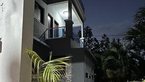 A multi-story building with a balcony on the second floor.
