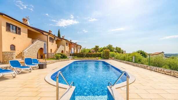 A swimming pool with lounge chairs, a stone staircase, and a view of the surrounding landscape. - Pool House Kristina near Poreč, Kaštelir - Labinci, Croatia (Kaštelir - Labinci)