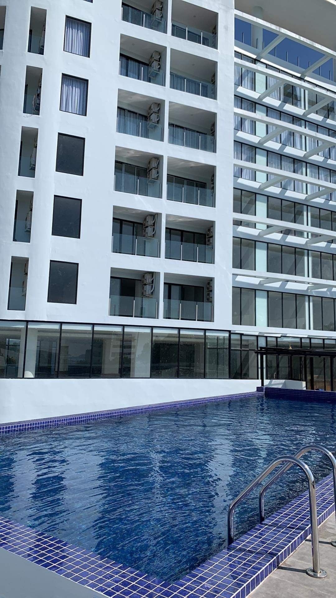 A modern hotel with a pool area.
