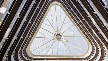 A multi-level atrium with a central skylight and curved balconies.
