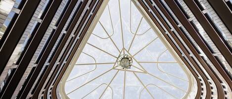 A multi-level atrium with a central skylight and curved balconies.