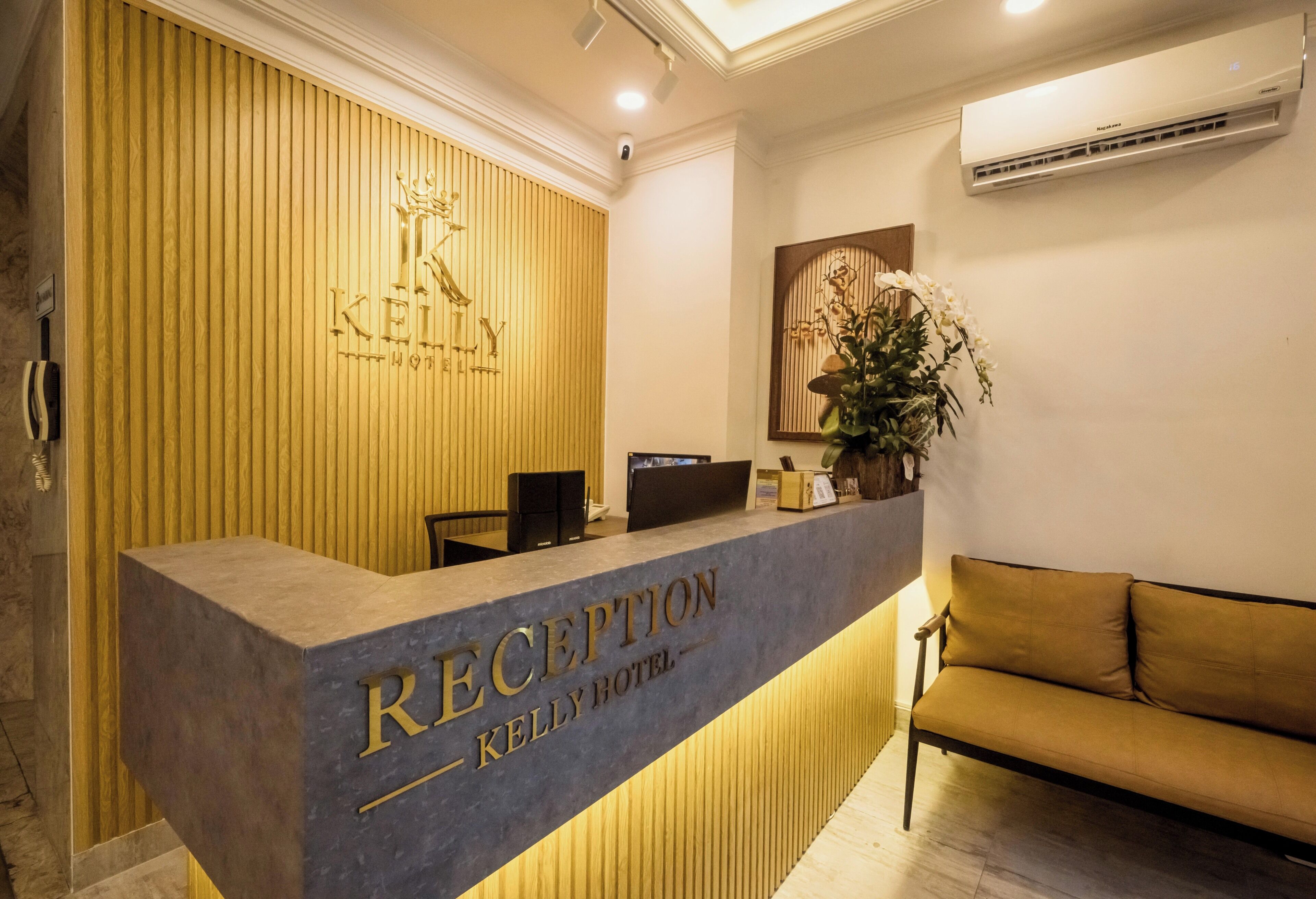 A reception desk with a wooden panel backdrop and a reception area.