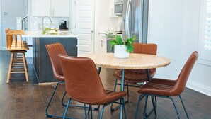 A modern kitchen with a central island, stainless steel appliances, and a chandelier. - The Teal Door Cottage-Spacious home with King suite (Nashville)