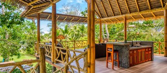 Jungle paradise on beach with open-air living, full kitchen, & shared pool