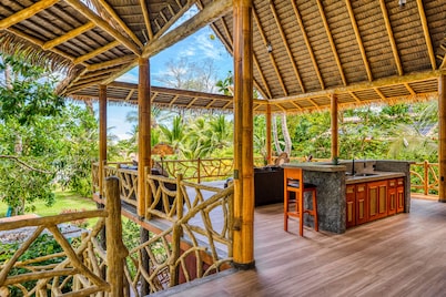 Jungle paradise on beach with open-air living, full kitchen, & shared pool