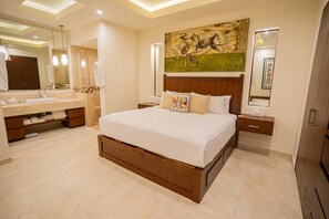 A modern bedroom with a large bed, a wooden headboard, a nightstand, a bedside table, a full-length mirror, and a bathroom with a sink and mirror. - Gorgeous 1 Bedroom Unit at V399, amazing Rooftop 1BD Condo for rent in Old Town, (Puerto Vallarta)
