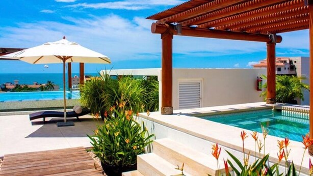 A pool area with a pergola, lounge chairs, and potted plants. - Gorgeous 1 Bedroom Unit at V399, amazing Rooftop 1BD Condo for rent in Old Town, (Puerto Vallarta)