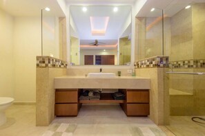 A modern bathroom with a large mirror, a sink, and a shower area. - Gorgeous 1 Bedroom Unit at V399, amazing Rooftop 1BD Condo for rent in Old Town, (Puerto Vallarta)