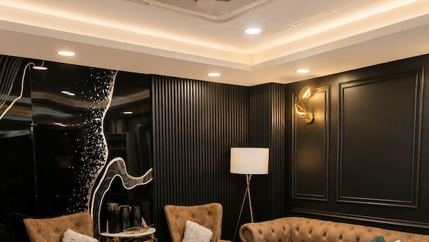 A modern living room with a sofa set, a side table, a floor lamp, and a patterned rug. - Raissa Boutique Hotel (Kuala Lumpur)