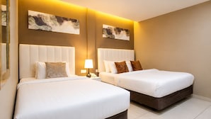 A hotel room with two beds, a nightstand with a lamp, and artwork on the walls. - Raissa Boutique Hotel (Kuala Lumpur)