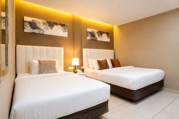 A hotel room with two beds, a nightstand with a lamp, and artwork on the walls. - Raissa Boutique Hotel (Kuala Lumpur)