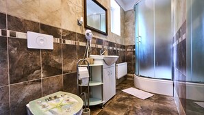 A modern bathroom with a toilet, sink, and shower. - Formanka by Interhome (Liberec)