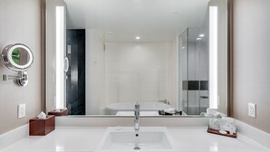 A modern bathroom with a large mirror, a white sink, and a glass shower enclosure. - Vdara Studio by Jet Luxury (Las Vegas)