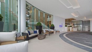 A modern lobby with seating areas, a staircase, and a reception desk. - 2 Bedroom Apartment With Private Plunge Pool (Surfers Paradise)
