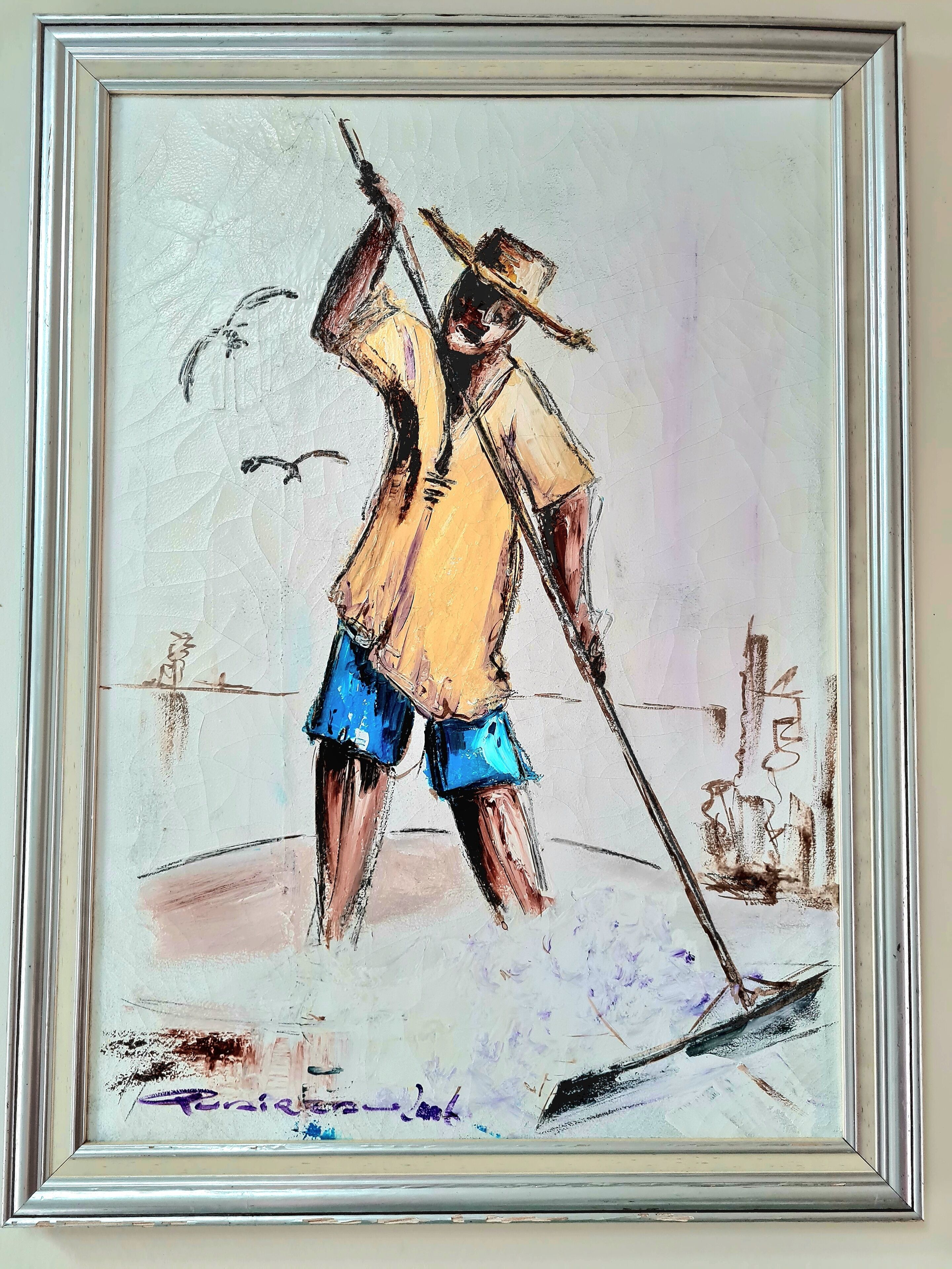 Un tableau encadré représentant une personne tenant un râteau.