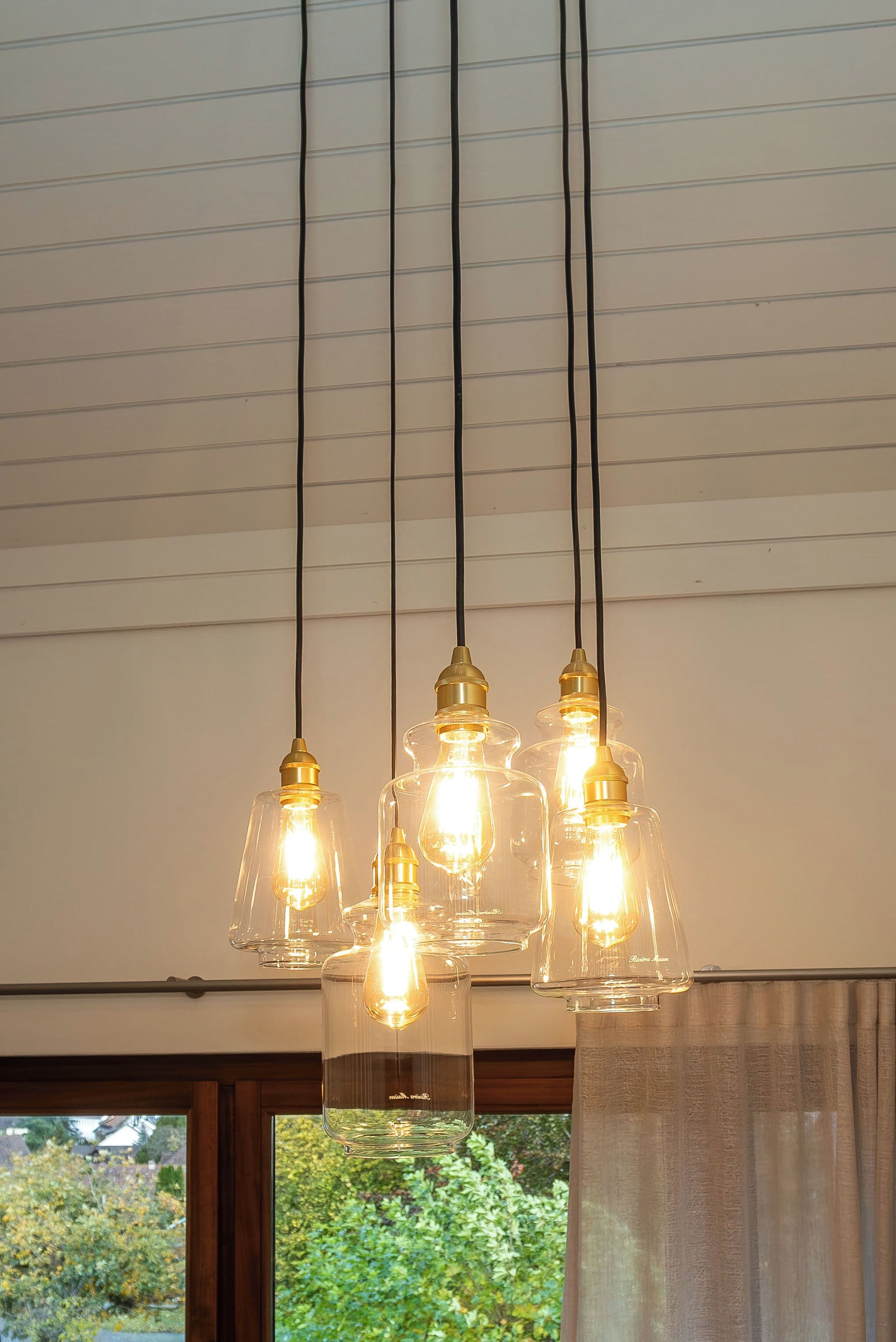 A ceiling with three hanging light fixtures.