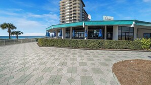 A beachfront hotel with a modern design, featuring a prominent building with balconies and a sign reading "Oceans".