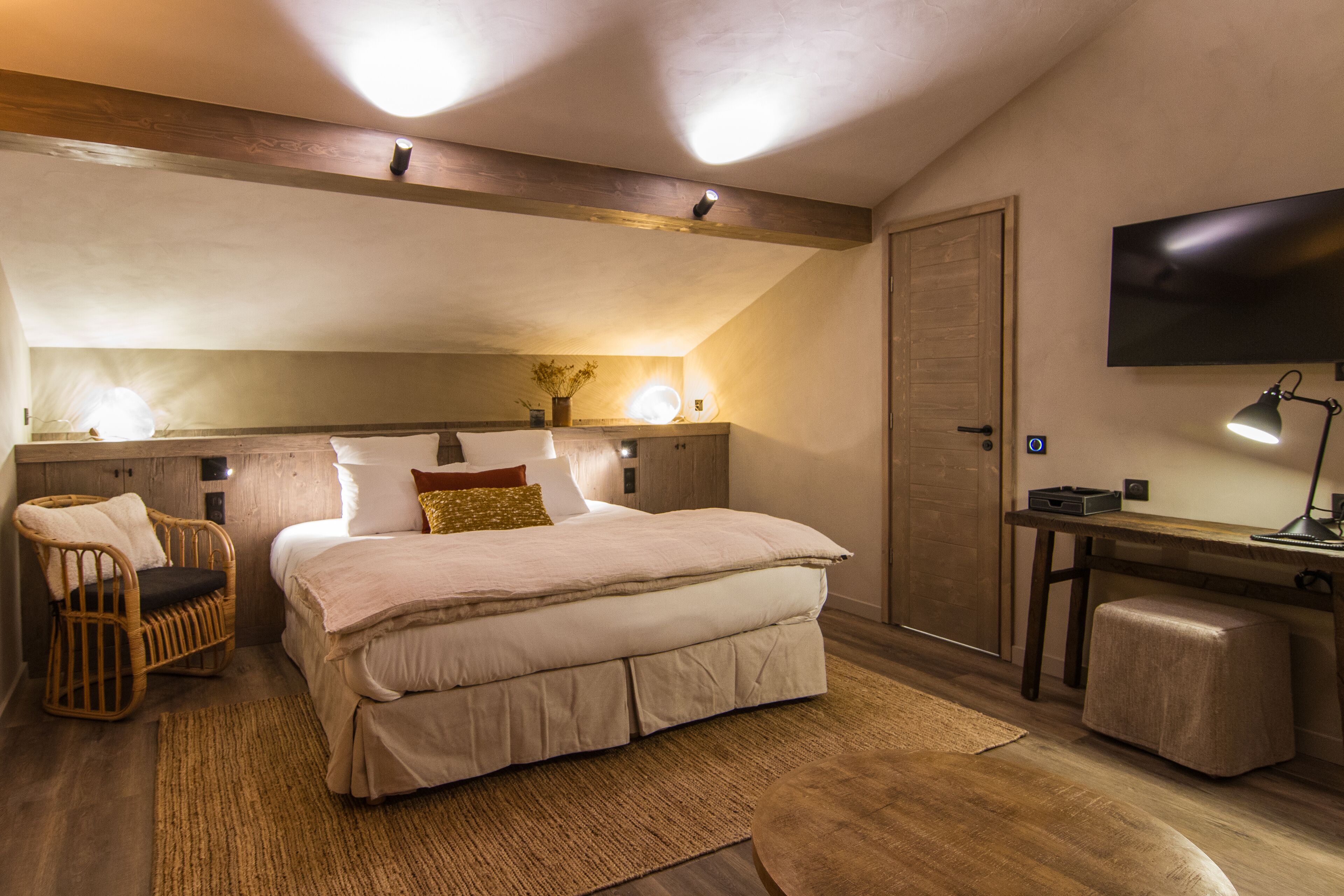 Una camera da letto con un letto grande, una scrivania, una sedia e una televisione.