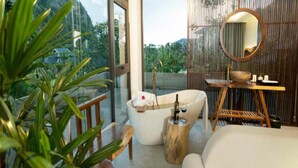 A modern bathroom with a freestanding bathtub, a wooden vanity, and a large mirror. - Minawa Kenhga Resort & Spa Ninh Binh (Gia Vien)