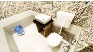 A bathroom with a sink, toilet, and bidet. - Sanjog Resort (Kota)