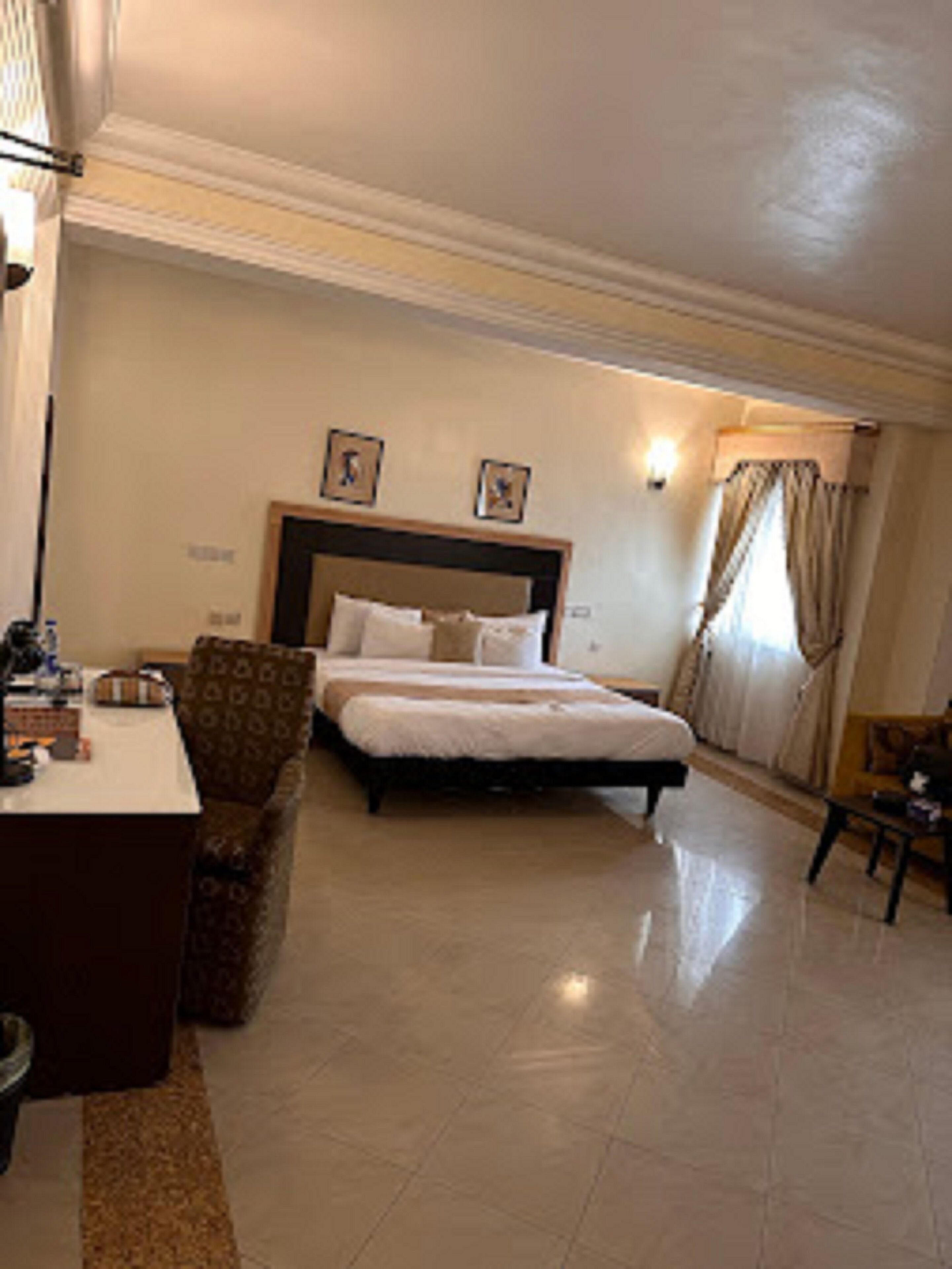 Una habitación de hotel con cama, escritorio y silla.
